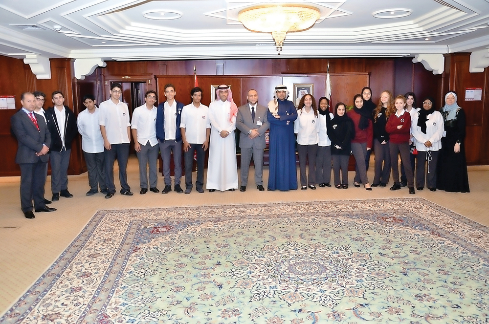 QIIB Chief Executive Officer, Abdulbasit Ahmad Al Shaibei and Deputy CEO Jamal Al Jamal with students of Qatar Academy at Banks headquarters.
