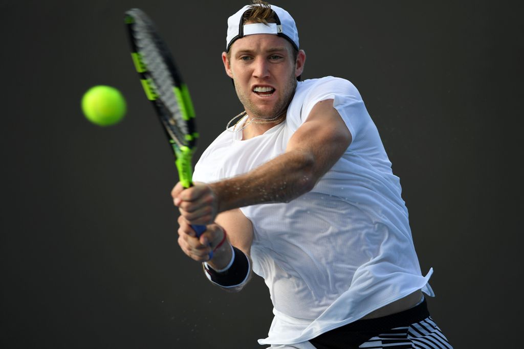 Jack Sock of the US hits a return against France's Pierre-Hughes Herbert during their men's singles match on day one of the Australian Open tennis tournament in Melbourne on January 16, 2017. AFP / Saeed KHAN