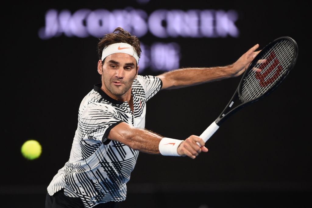 Switzerland's Roger Federer hits a return against Austria's Jurgen Malzer during their men's singles match on day one of the Australian Open tennis tournament in Melbourne on January 16, 2017. AFP / PETER PARKS