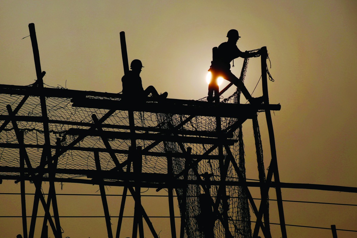 Workers build scaffolding at a construction site in Beijing.