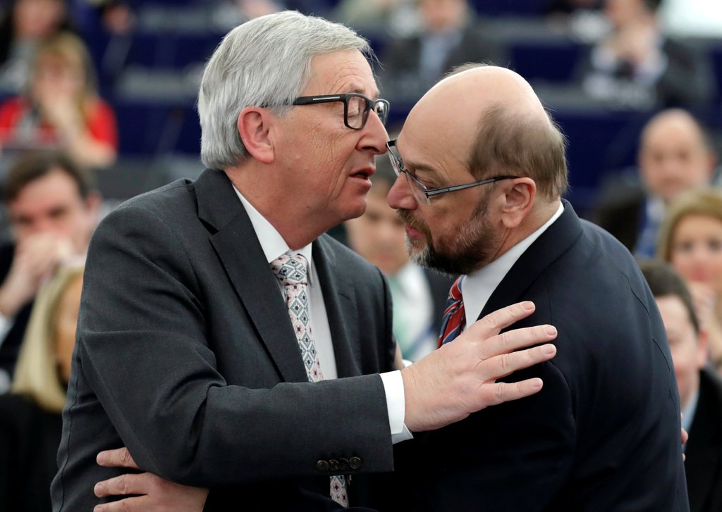 European Commission President Jean-Claude Juncker (L) and former President of the European Parliament President Martin Schulz embrace during a debate on the priorities of the incoming Malta Presidency of the EU for the next six months at the European Parl