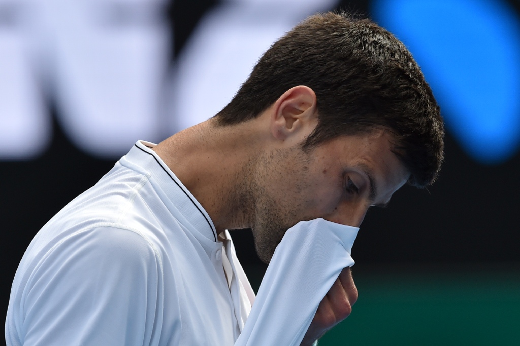 Serbia's Novak Djokovic reacts after a point against Uzbekistan's Denis Istomin during their men's singles match on day four of the Australian Open tennis tournament in Melbourne on January 19, 2017.  AFP / PAUL CROCK