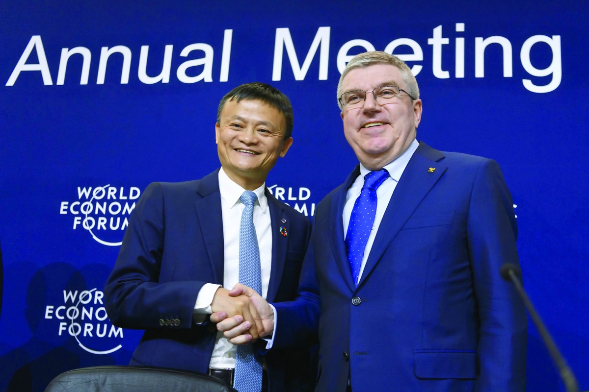 Alibaba Group Founder and Executive Chairman, China's Jack Ma (left) shakes hands with International Olympic Committee (IOC) President Thomas Bach in Davos, Switzerland yesterday.