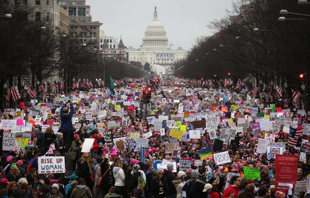 Protesters walk up Pennsylvania Avenue during the Women's March on Washington, with the U.S. Capitol in the background, on January 21, 2017 in Washington, DC. Large crowds are attending the anti-Trump rally a day after U.S. President Donald Trump was swor