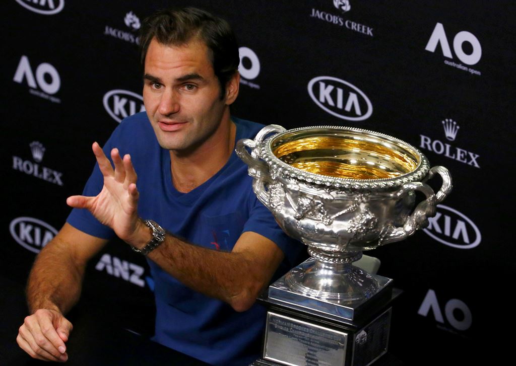 Tennis - Australian Open - Melbourne Park, Melbourne, Australia - early 30/1/17 Switzerland's Roger Federer gestures during a post-match news conference next to his Men's singles final trophy. Reuters/Edgar Su
