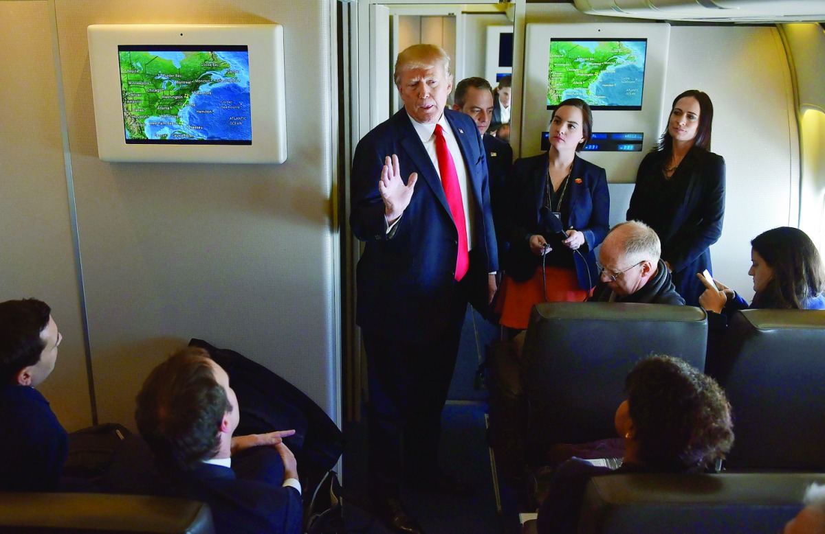 US President Donald Trump chats with reporters on board Air Force One before departing from Andrews Air Force Base in Maryland, bound for Palm Beach, Florida on February 3, 2017. (AFP / MANDEL NGAN)