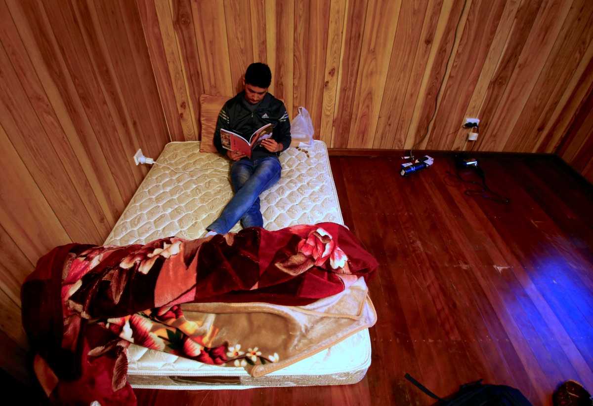 REPRESENTATIVE IMAGE: Ali Rasooli, a refugee from Afghanistan sits on his mattress reading a book in a house he rents with other refugees in the western Sydney suburb of Guildford, Australia, July 17, 2016 (REUTERS / David Gray) 