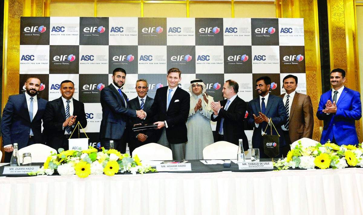 Thibaud de Lisle (fifth left), Managing Director, Total Marketing Middle East FZE and Total Lubricant Blending Unit; shakes hands with Hisham Hadid, CEO, Arabian Supply Centre (ASC), after signing a distributorship agreement at a function held at the Sher