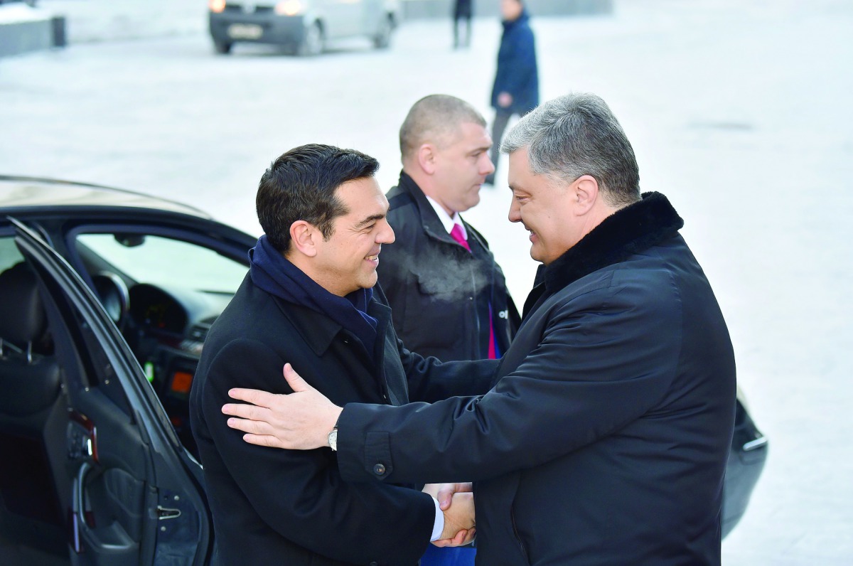 Ukrainian President Petro Poroshenko (right) welcomes Greek Prime Minister Alexis Tsipras prior to their talks in Kiev, yesterday. Tsipras is in Ukraine for a two-day working visit. 