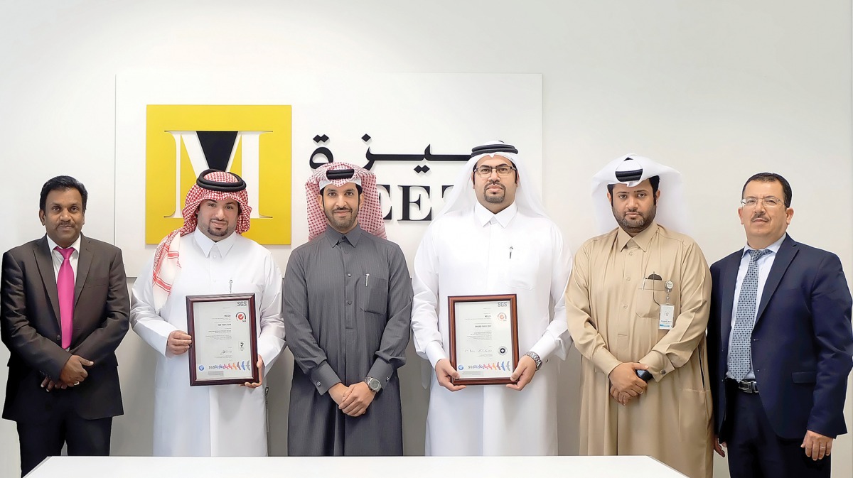 MEEZA Executive Team members receive certifications from SGS representative.