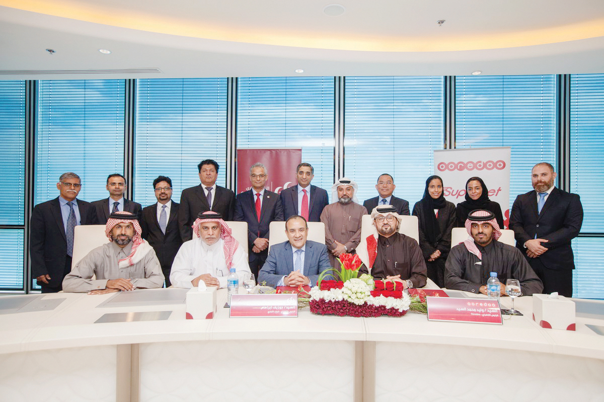 Waleed Al Sayed (second right), Chief Executive Officer of Ooredoo Qatar;  Joseph Abraham (centre), CEO of Commercial Bank and other senior officials at the signing ceremony held at Commercial Bank Plaza.