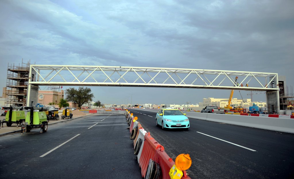 Workers installing new pedestrian bridge on E-Ring road, which will connect Old Airport (zone 45) to Al Rawda (zone 47) in front of traffic department office at Old Airport. The bridge will have elevators on both sides. Abdul Basit © The Peninsula