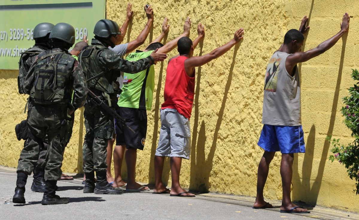 Army soldiers check people, during a military police strike over wages, while patrolling the streets of Vila Velha, Espirito Santo, Brazil, February 11, 2017. REUTERS/Paulo Whitaker