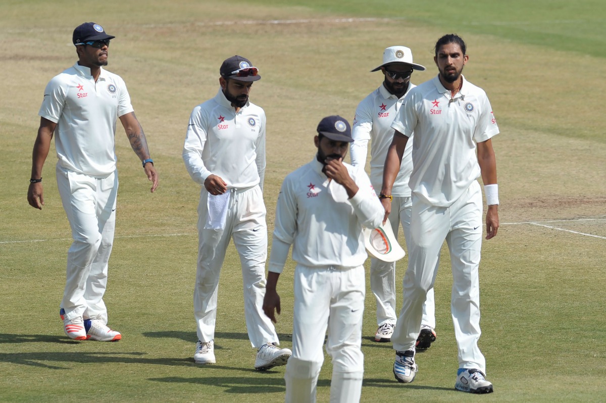 India's captain Virat Kohli (2L) walks with teammates on the fifth day of a solo Test match between India and Bangladesh at the Rajiv Gandhi International Cricket Stadium on February 13, 2017. (AFP / NOAH SEELAM)