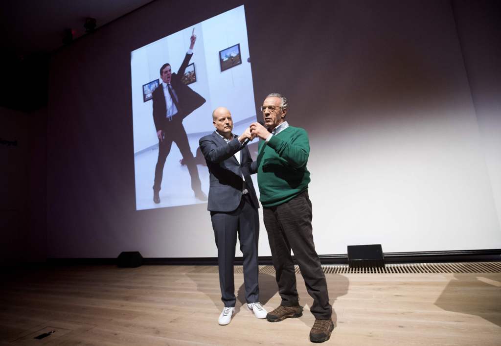 Winner of the World Press Photo 2016 photographer Burhan Ozbilici (R) and Managing Director of the World Press Photo Foundation Lars Boering, speak on stage during the announcement of the World Press Photo prizes in Amsterdam, on February 13, 2017.  AFP /