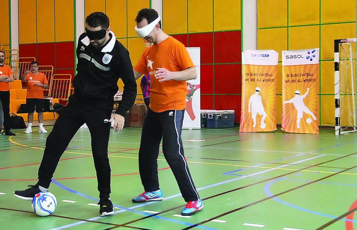 Football superstar Xavi Hernandez (left) in action during a special event hosted by Save the Dream on the occasion of National Sport Day at Qatar Foundation yesterday.