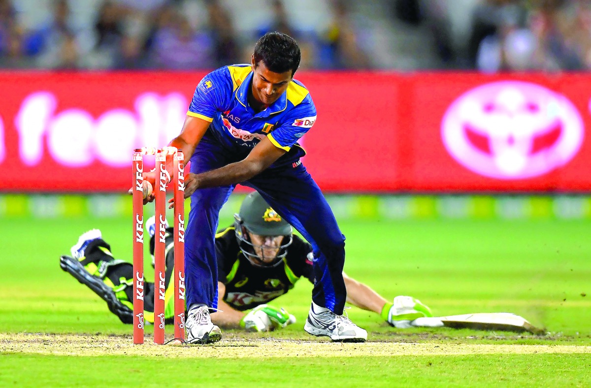 Australia's Tim Paine (behind-on ground) is run out by Nuwan Kulasekara of Sri Lanka during their first Twenty20 cricket match played at the MCG in Melbourne yesterday. 