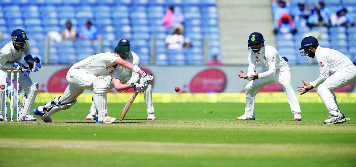 India's Wriddhiman Saha (left), Ajinkya Rahane (third left),  Murali Vijay (second right) and captain Virat Kohli (right) watch  as Australia's Matthew Renshaw plays a defensive shot during the first day of their first Test at the Maharashtra Cricket Asso