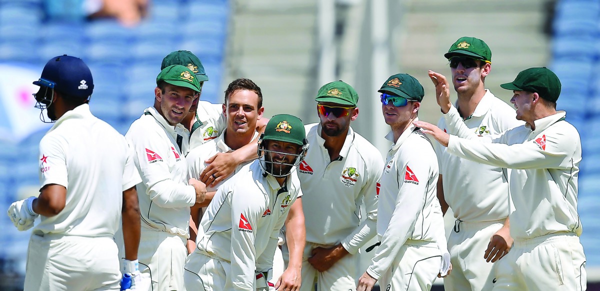 Australia's Steve O'Keefe (third left) is congratulated by team-mates after his dismissal of India's Murali Vijay on the third day of their first Test in Pune on February 25. Australia will head into the Bengaluru Test  with a 1-0 lead.   