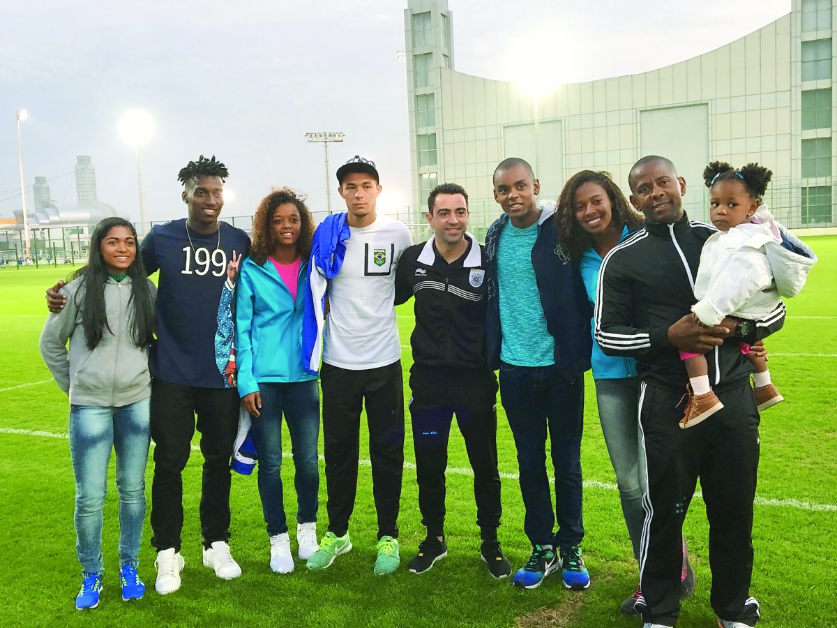 Football legend Xavi Hernandez (centre) poses for a photograph with Shine athletes at Al Sadd training ground. 