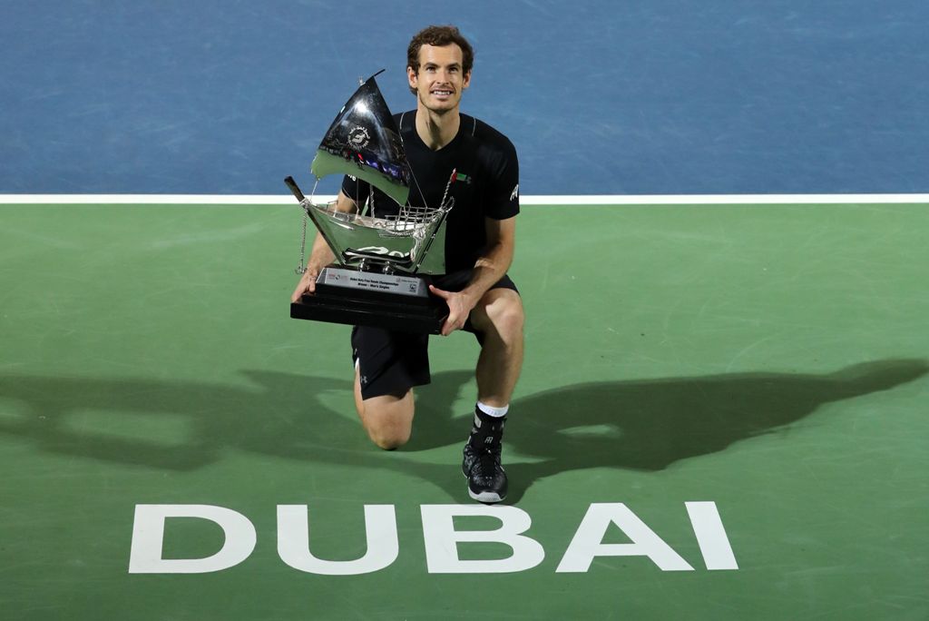 World number one Andy Murray of Great Britain celebrates with the championship trophy after winning his ATP final tennis match against Spain's Fernando Verdasco, during the Dubai Duty Free Championships on March 4, 2017.  AFP / KARIM SAHIB
