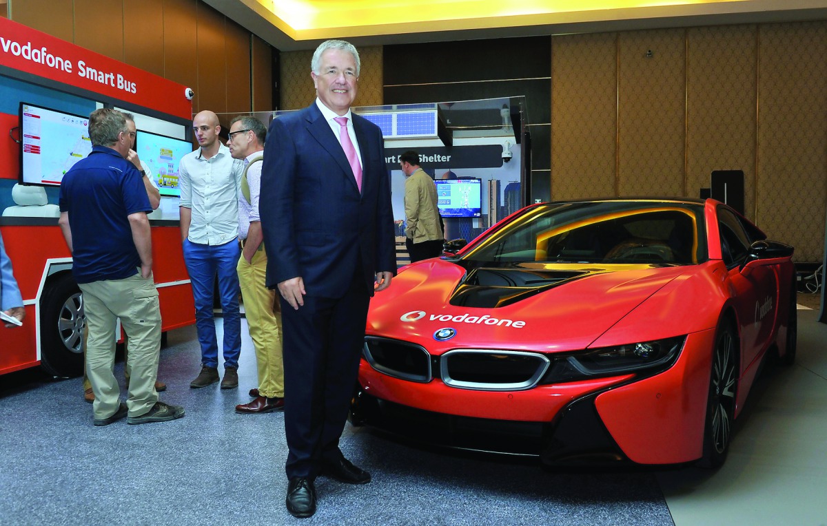 Vodafone Qatar CEO Ian Gray posing  for a picture in front of Vodafone's IoT powered Connected Car. Pic: Kammutty VP/The Peninsula.

