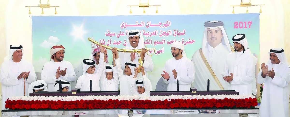 Emir H H Sheikh Tamim bin Hamad Al Thani awards the Sword of H H the Emir to the winners of the annual festival of Arabian Thoroughbred Camel Race, held at Al Shahania camel racetrack yesterday.