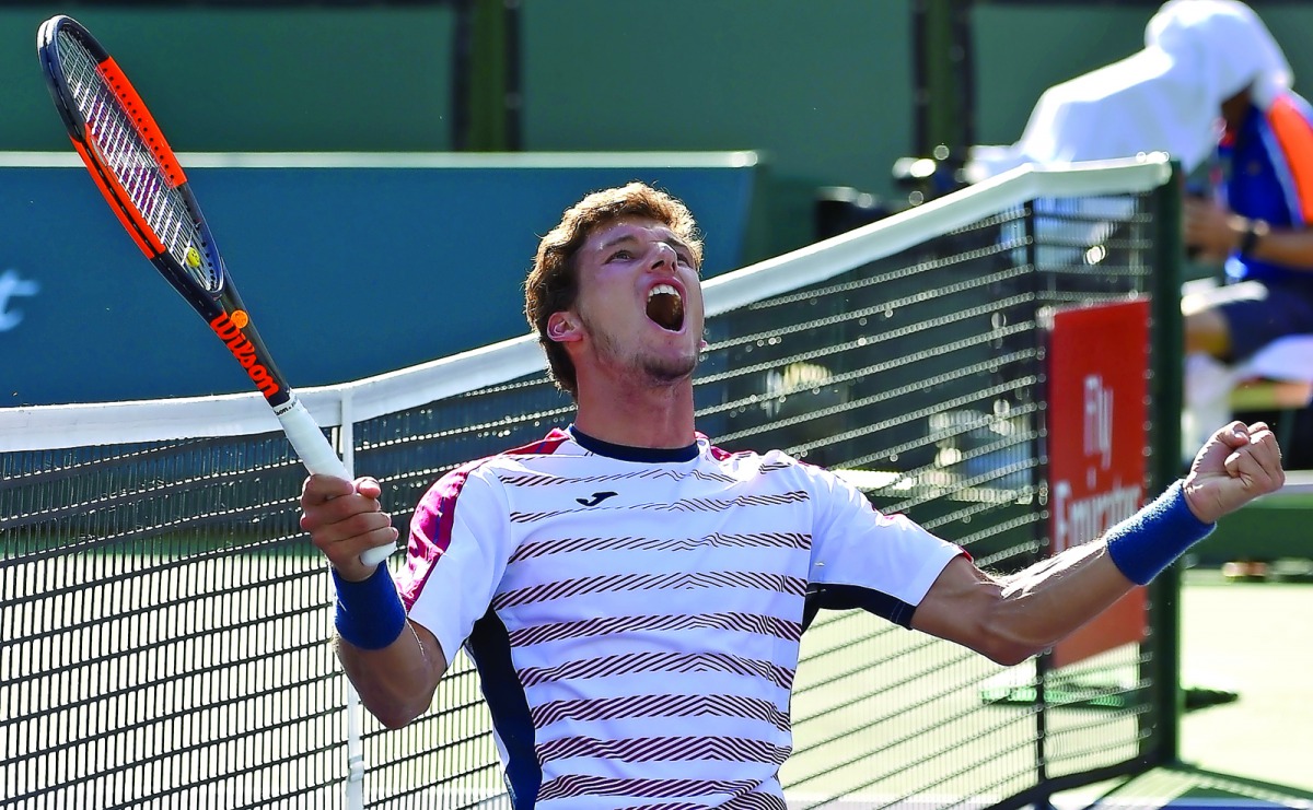 Pablo Carreno Busta of Spain celebrates hi match point as he defeated Pablo Cuevas in his quarter final match in the BNP Paribas Open at the Indian Wells Tennis Garden on Thursday.