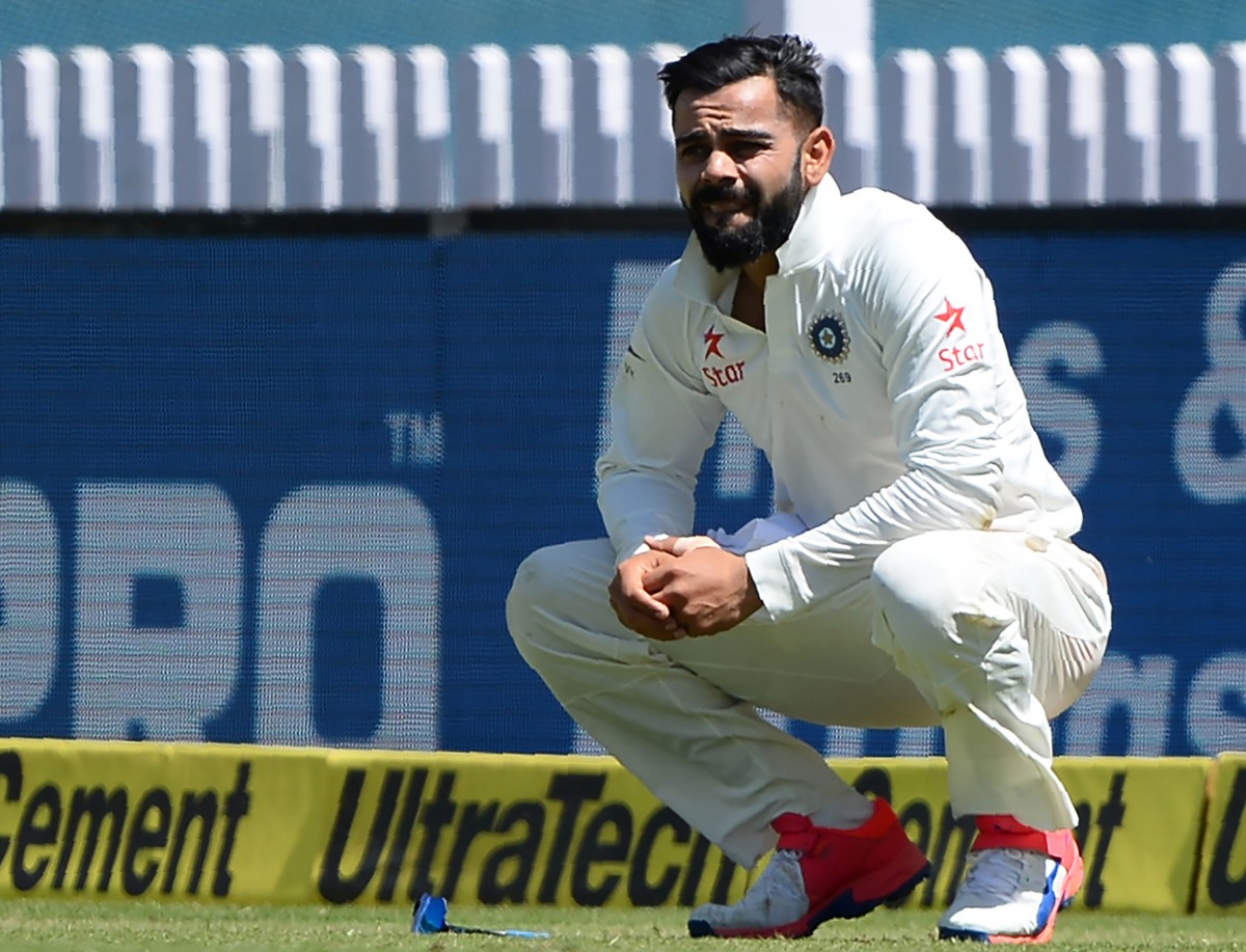 India's captain Virat Kohli reacts after he was injured while fielding during the first day of the third Test cricket match between India and Australia at The Jharkhand State Cricket Association (JSCA) Stadium Complex in Ranchi on March 16, 2017. (AFP / S