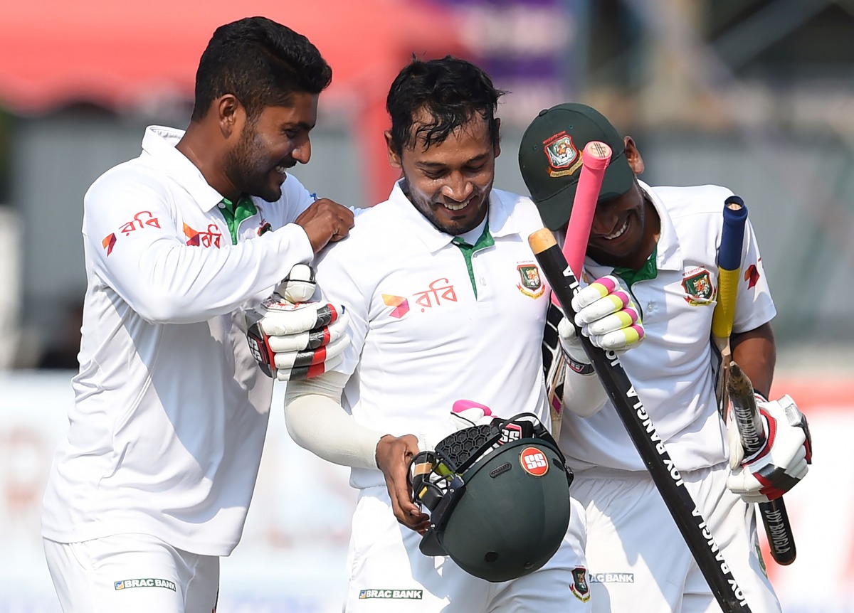 Bangladesh captain Mushfiqur Rahim (C) and teammates celebrate their victory over Sri Lanka by four wickets on the fifth and final day of the second and final Test cricket match between Sri Lanka and Bangladesh at The P. Sara Oval Cricket Stadium in Colom