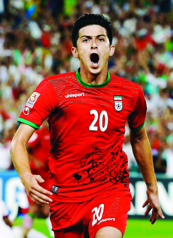 Iran’s Sardar Azmoun celebrates after scoring a goal against Qatar at the Stadium Australia in Sydney in this January 2015 file picture.