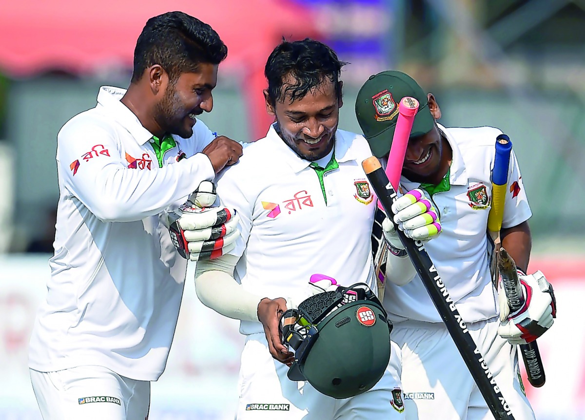 Bangladesh captain Mushfiqur Rahim (centre) and team-mates celebrate their victory over Sri Lanka on the fifth and final day of the second and final Test at The P. Sara Oval Cricket Stadium in Colombo on Sunday. 