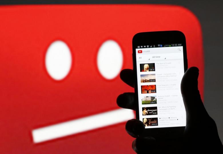 A picture illustration shows YouTube on a cell phone in front of a YouTube copyright message regarding a video on an LCD screen in central Bosnian town of Zenica, June 18, 2014 (REUTERS / Dado Ruvic) 