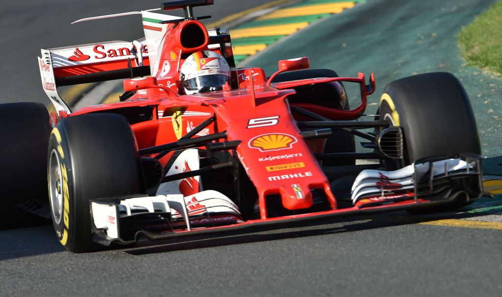 Ferrari's German driver Sebastian Vettel powers through a corner during the Formula One Australian Grand Prix in Melbourne on March 26, 2017. / AFP / PAUL CROCK
