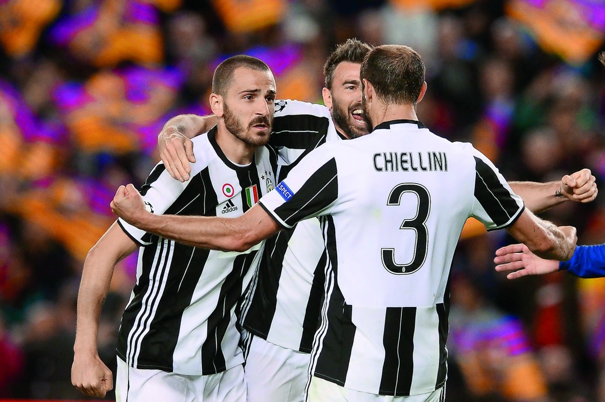 Juventus' defender Giorgio Chiellini (right) celebrates their qualification with team-mates at the end of the UEFA Champions League quarter-final second leg match against FC Barcelona at the Camp Nou Stadium in Barcelona on Wednesday. Juve claimed a 3-0 w