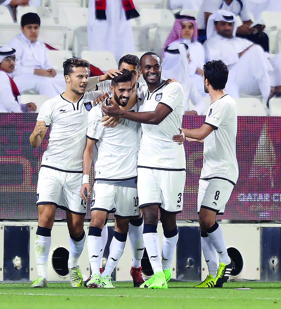Al Sadd players celebrate after Hassan Haydoos (second left) scores their second goal during the first Qatar Cup semi-final against Al Rayyan at Jassim bin Hamad Stadium yesterday. Al Sadd won the match 3-2 to enter the final which will be played on April