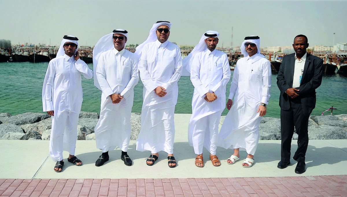Hamad Murshid jabr Al Khanji, Head of Fishing Ports at the Ministry of Municipality and Environment, and Capt. Abdulla Al Khanji, CEO of Mwani (third left), and other officials during the opening of Al Wakrah Port's new harbour, yesterday. Pic: Abdul Basi