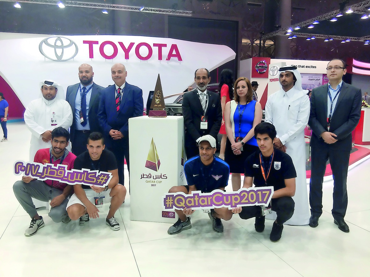 Officials and others with Qatar Cup Trophy at the booth.
