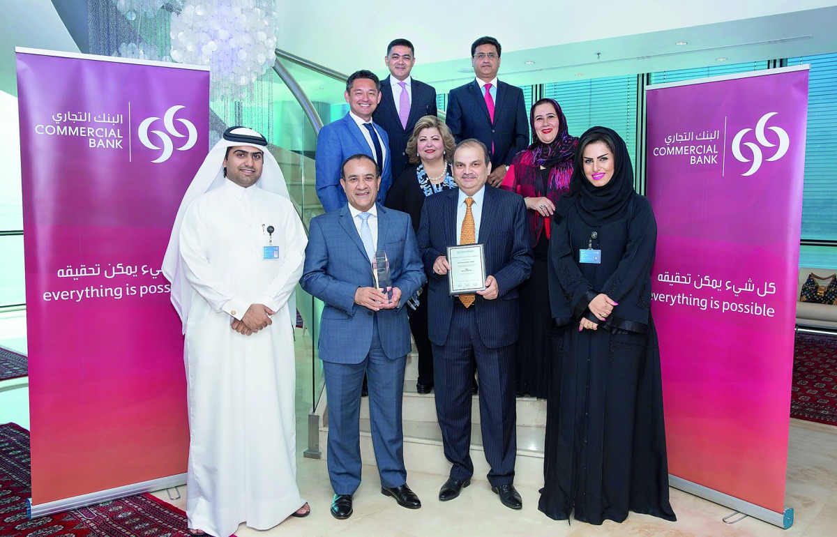 Commercial Bank CEO Joseph Abraham (second left) and other officials with the two awards.