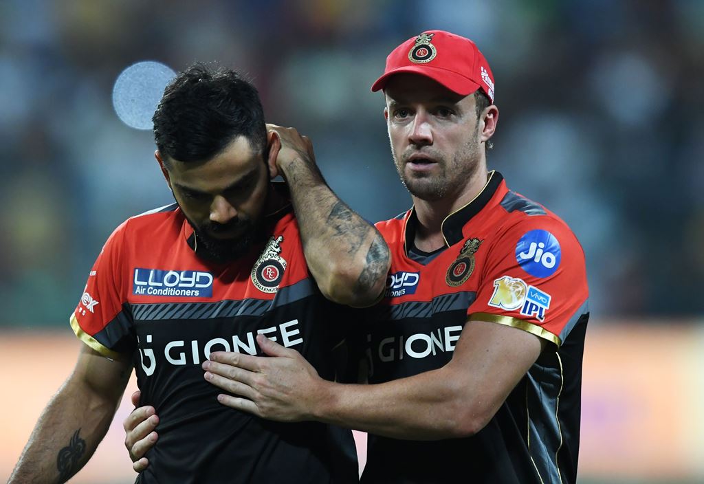Royal Challengers Bangalore captain Virat Kohli reacts as teammate AB de Villiers(R) consoles him during the 2017 Indian Premier League (IPL) Twenty20 cricket match between Kolkata Knight Riders and Royal Challengers Bangalore at The Eden Gardens Cricket 