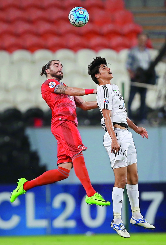 Lekhwiya's Spanish defender Chico Flores (left) locked in an areal battle for supremacy with Al Jazira's Emirati forward Ahmed Al Attas during their AFC Champions League Group B match played at the Mohammed Bin Zayed Stadiun in Abu Dhabi yesterday.