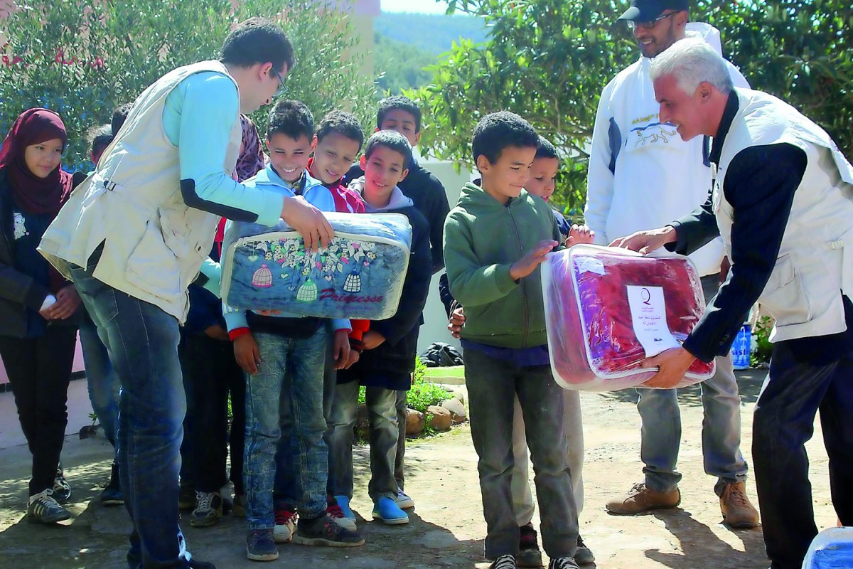 Children receiving blankets and other winter clothings in Tunisia.