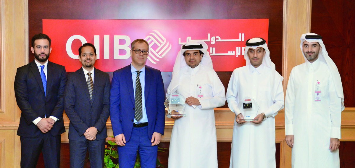 Abdulbasit Ahmad Al Shaibei, QIIB Chief Executive Officer (third right), Jamal Abdullah al-Jamal (second right), QIIB Deputy CEO and other officials pose for a group photo with the award at the event.