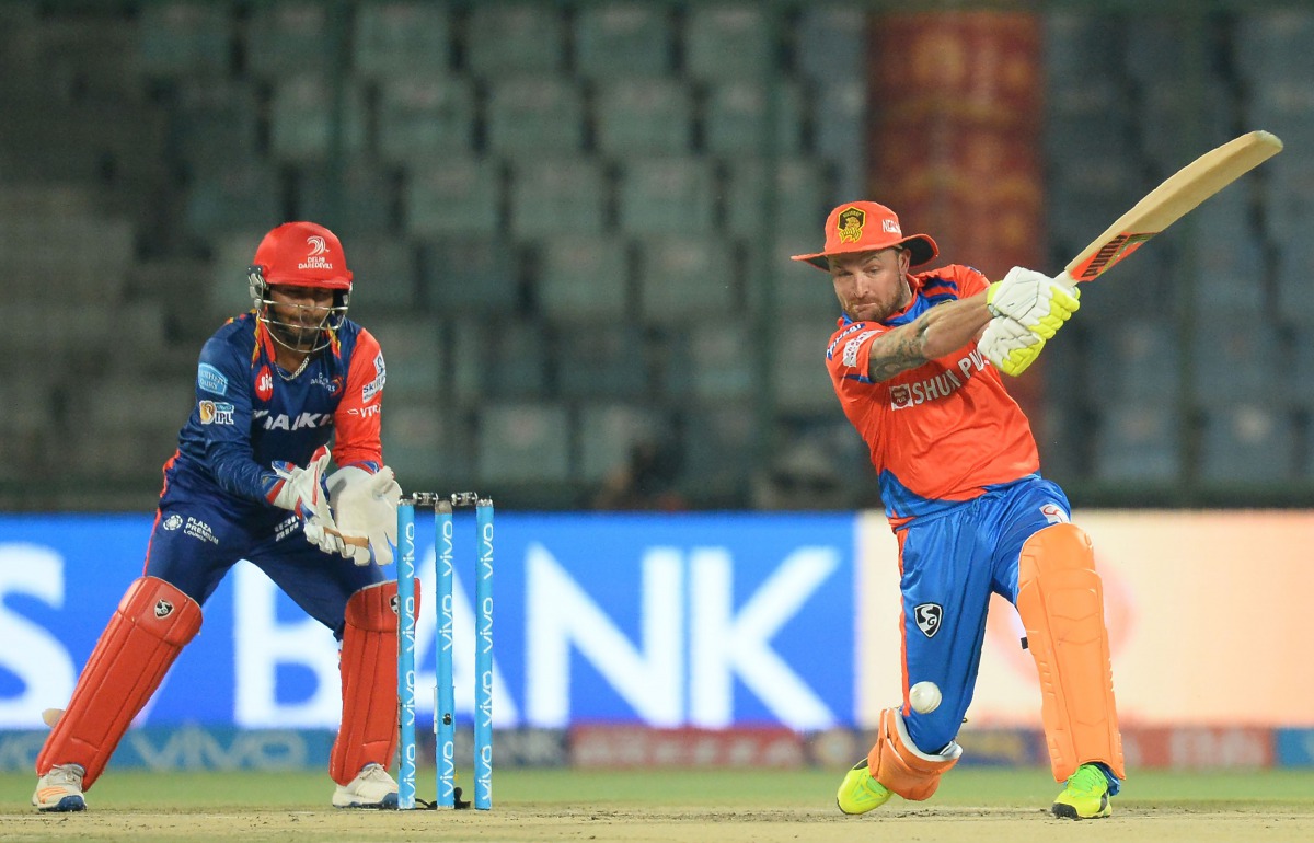 Gujarat Lions batsman Brendom McCullum (R) is watched by Delhi Daredevils wicketkeeper Rishabh Pant as he plays a shot during the 2017 Indian Premier League (IPL) Twenty20 cricket match between Delhi Daredevils and Gujarat Lions at The Feroz Shah Kotla Cr