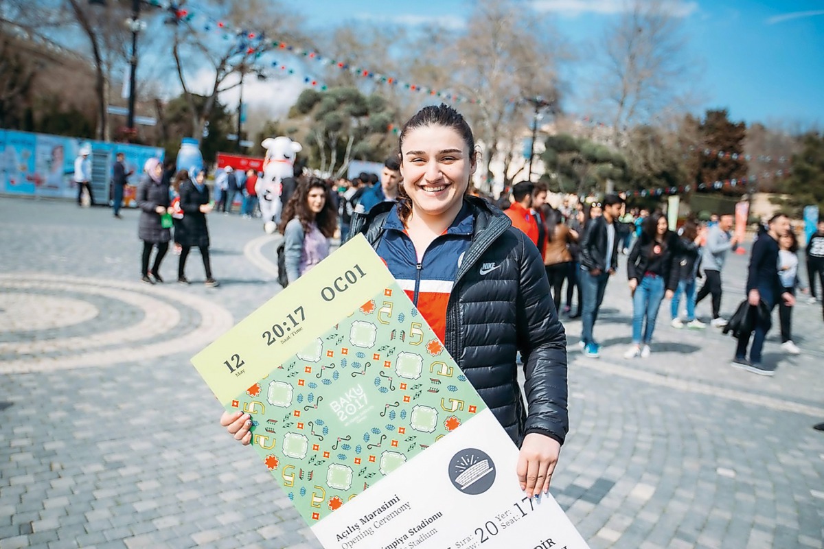 A volunteer  shows a token ticket for Baku 2017 Games.