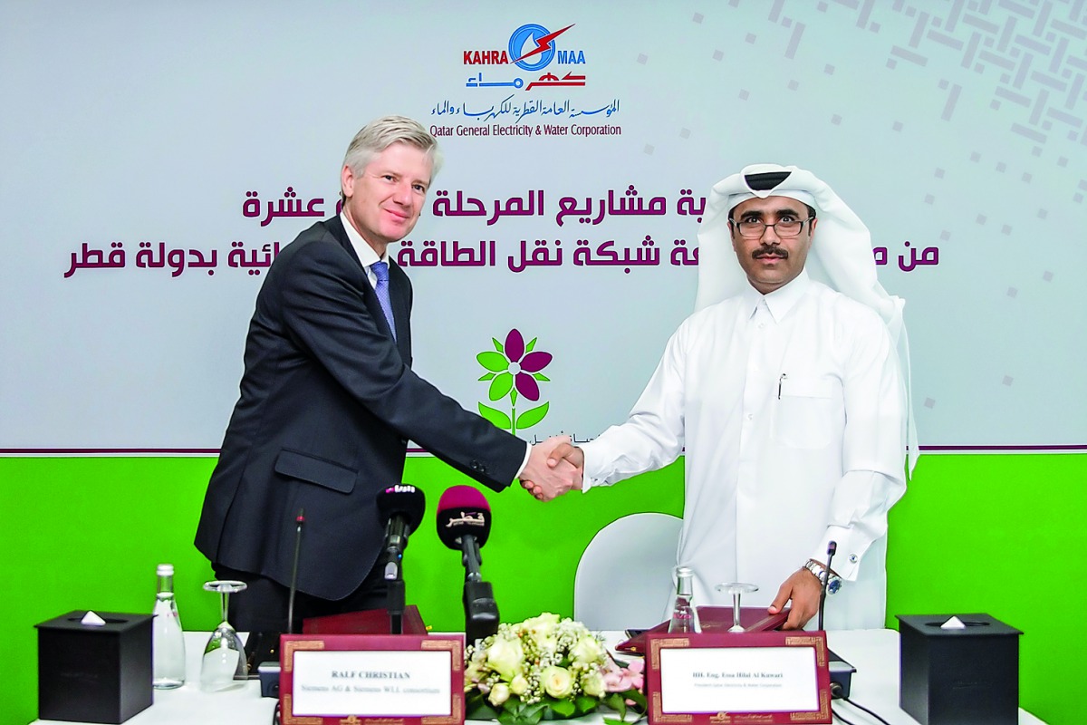 Qatar General Electricity and Water Corporation (Kahramaa) President Essa bin Hilal Al Kuwari and Ralf Christian, CEO of Siemens Energy Management Division, after the deal announcement  in Doha, yesterday.
