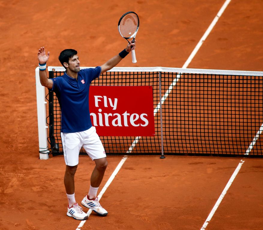 Serbian tennis player Novak Djokovic celebrates his victory over Spanish tennis player Nicolas Almagro during the ATP Madrid Open in Madrid, on May 10, 2017. Djokovic won 6-1, 4-6 and 7-5. / AFP / OSCAR DEL POZO
