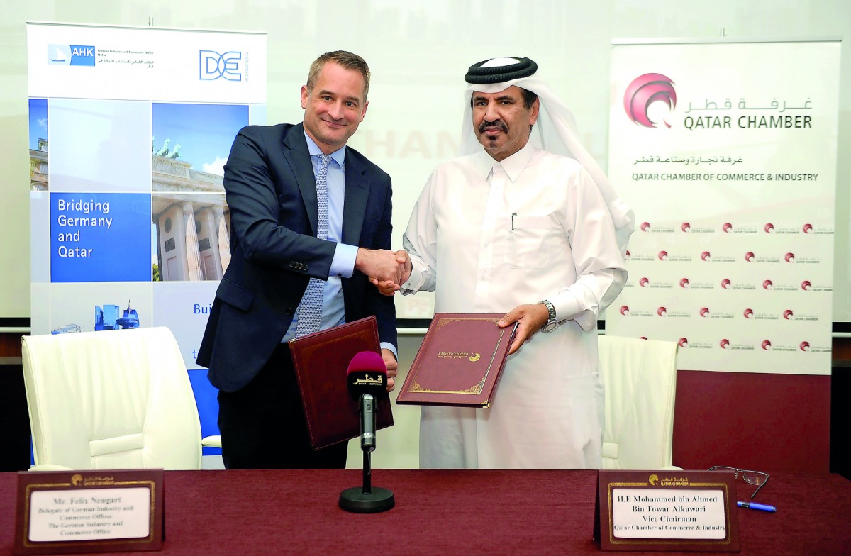 Mohammad bin Ahmed bin Towar Al Kuwari, Vice-Chairman of Qatar Chamber (right) exchanging documents with Felix Neugart, at the signing ceremony. Pic: Abdul Basit/The Peninsula