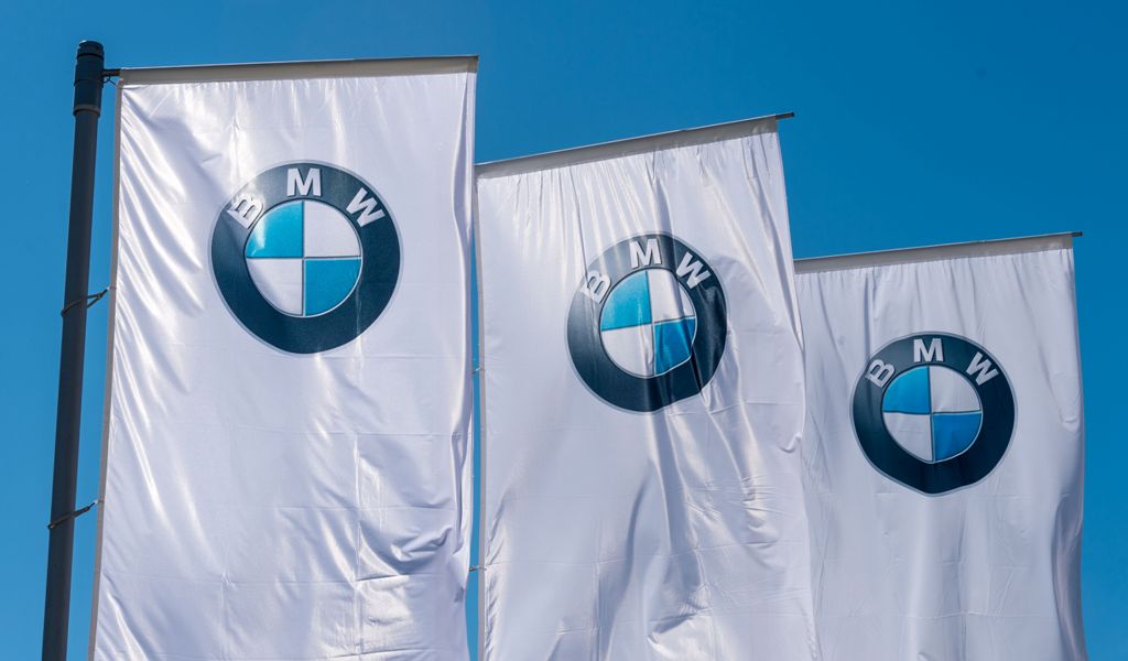 Flags with the BMW logo are pictured prior to the annual general meeting in Munich on May 11, 2017.  AFP / Alexander Heinl
