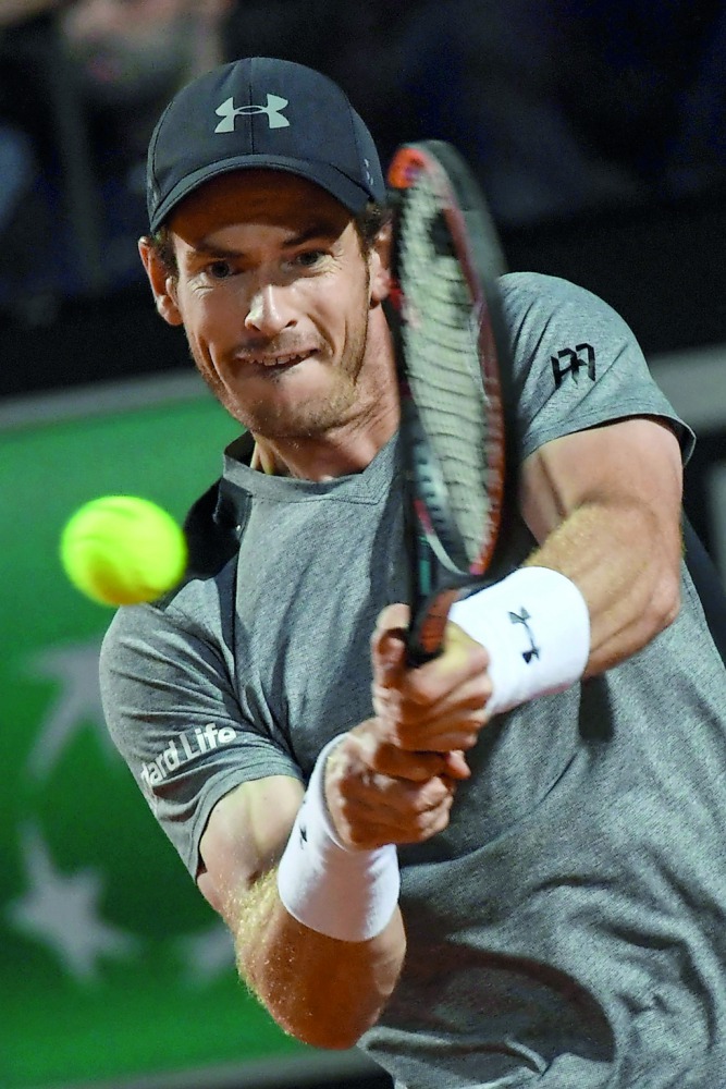Britain's Andy Murray returns the ball to Italy's Fabio Fognini during their Rome ATP Tennis Open tournament match on Tuesday. Murray was beaten by local favourite Fabio Fognini 6-2, 6-4.